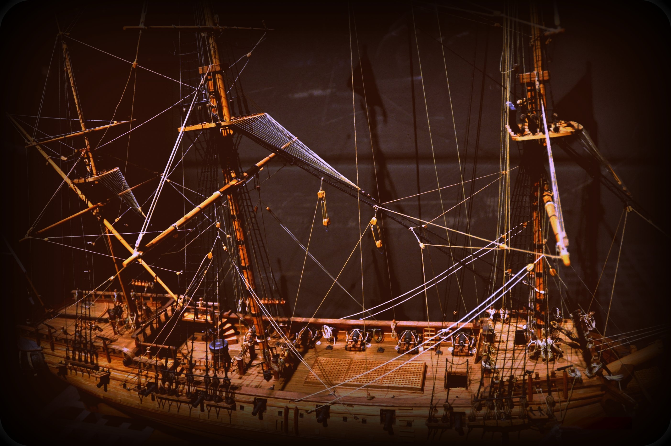 Modern scale model of the Whydah Gally, fully rigged with three masts and gun ports visible along the hull.